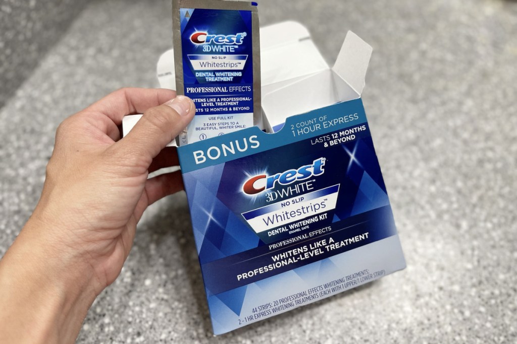 crest whitestrips in hand coming out of box