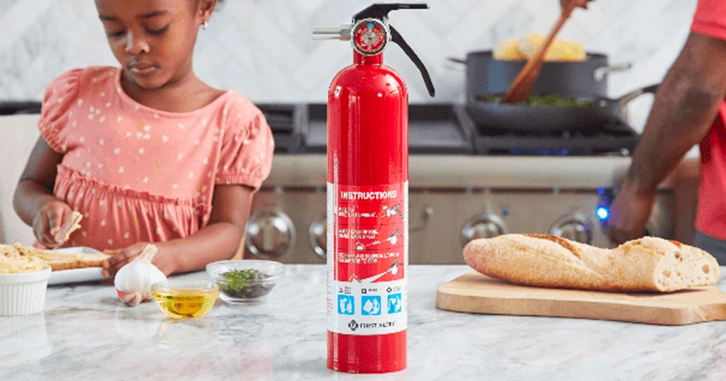 red fire extinguishers on counter in kitchen