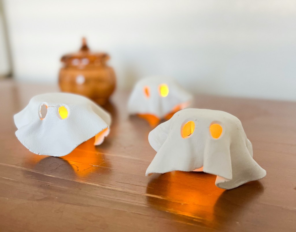 tealight ghosts sitting on wood table