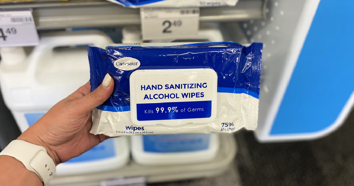 hand holding a pack of hand sanitizing wipes