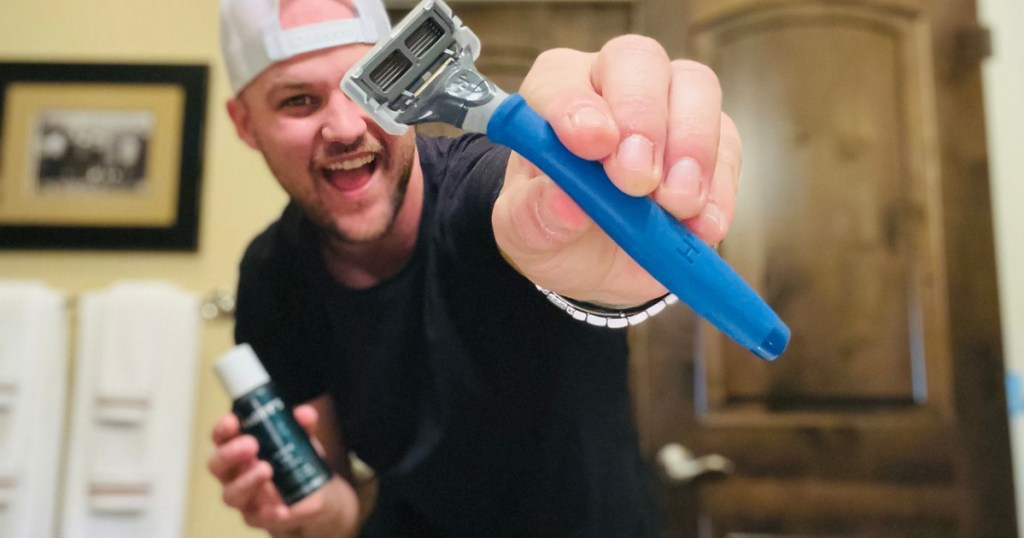 man holding a razor and shave gel