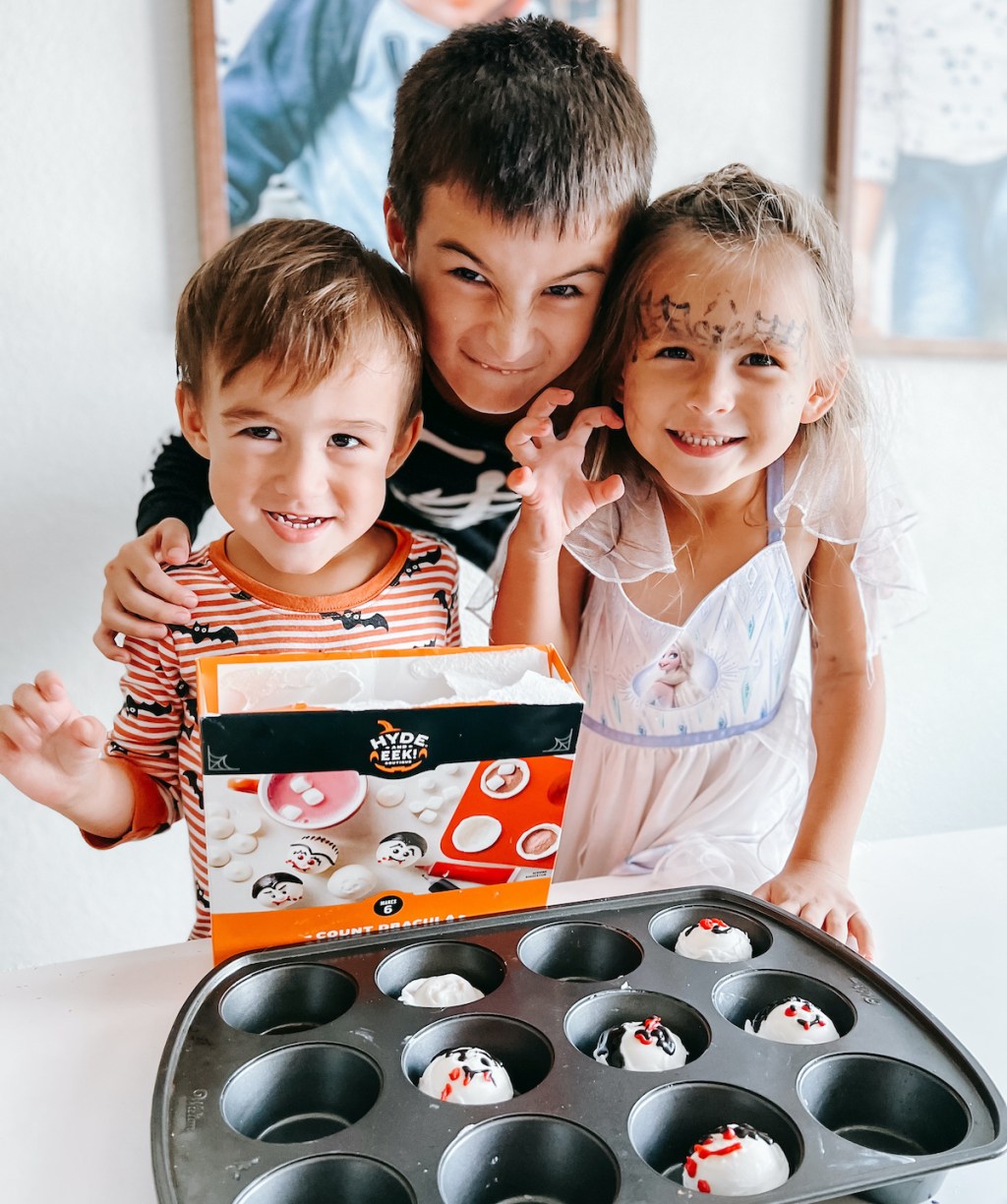 kids standing in front of halloween hot cocoa bombs kit