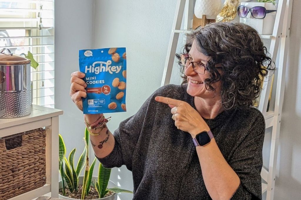woman pointing at a package of keto cookies