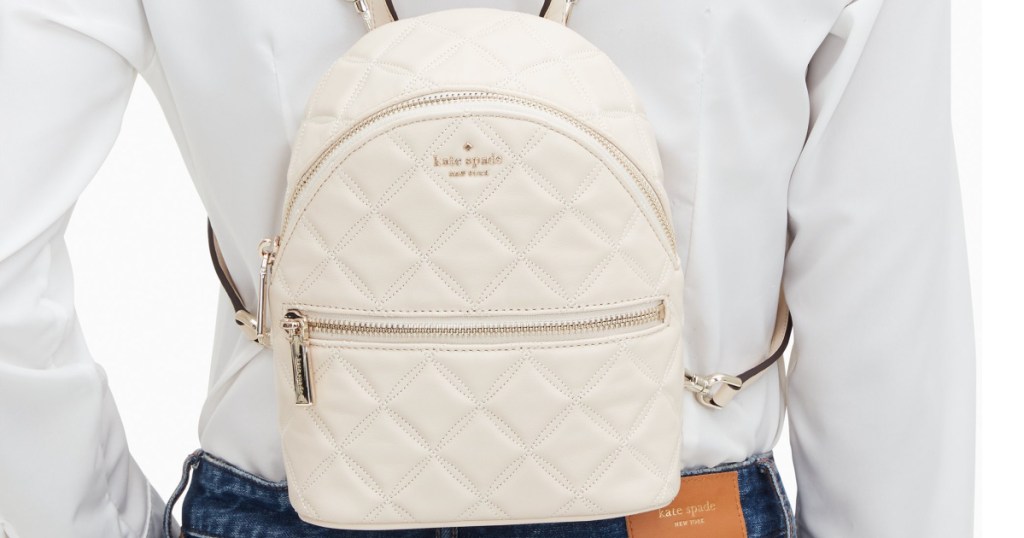 kate spade white quilted backpack on womans back
