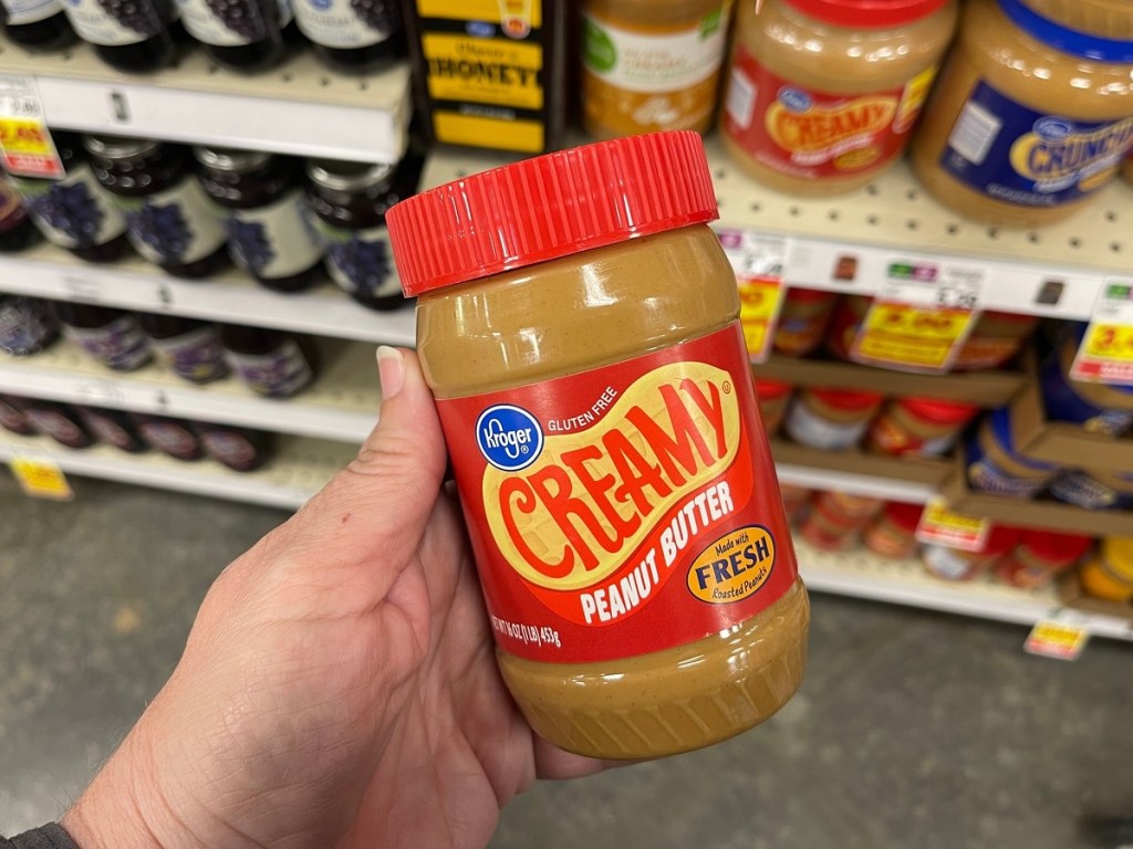 holding Kroger brand peanut butter