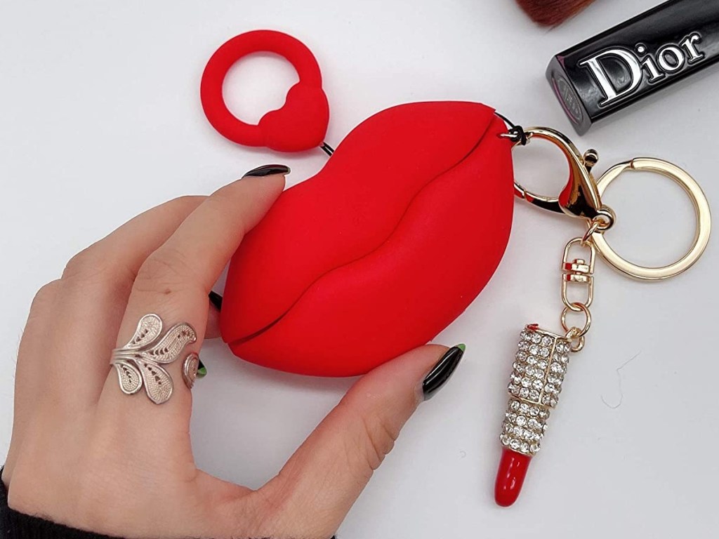 holding AirPods case shaped like red lips