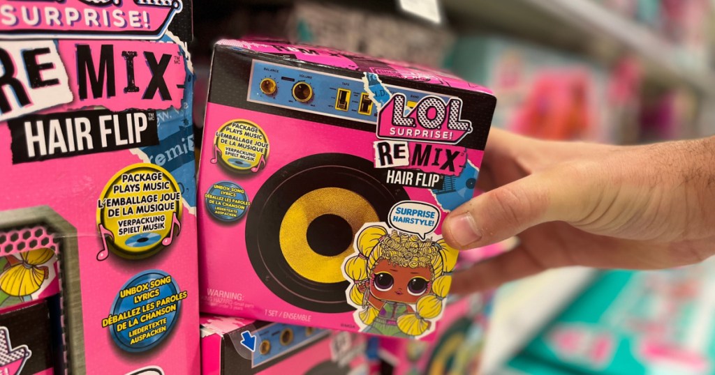 hand tipping an lol surprise doll in package off a target store shelf