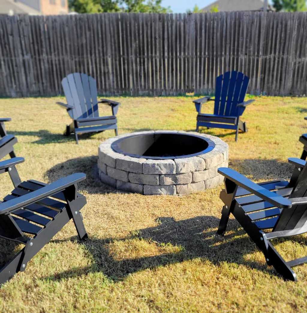firepit with black outdoor chairs outside