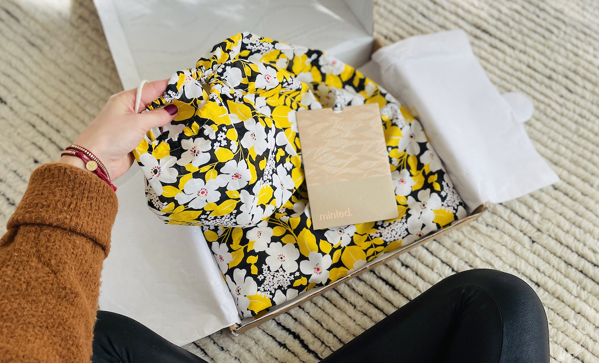 hand taking out floral bag from box