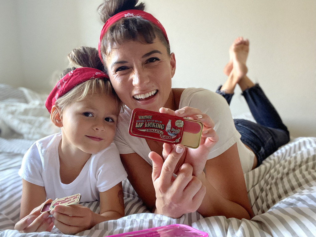 mom and daughter holding lip products 