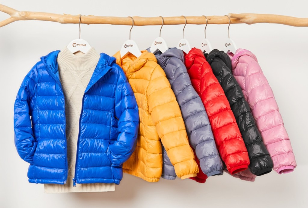 puffer jackets hanging from a branch