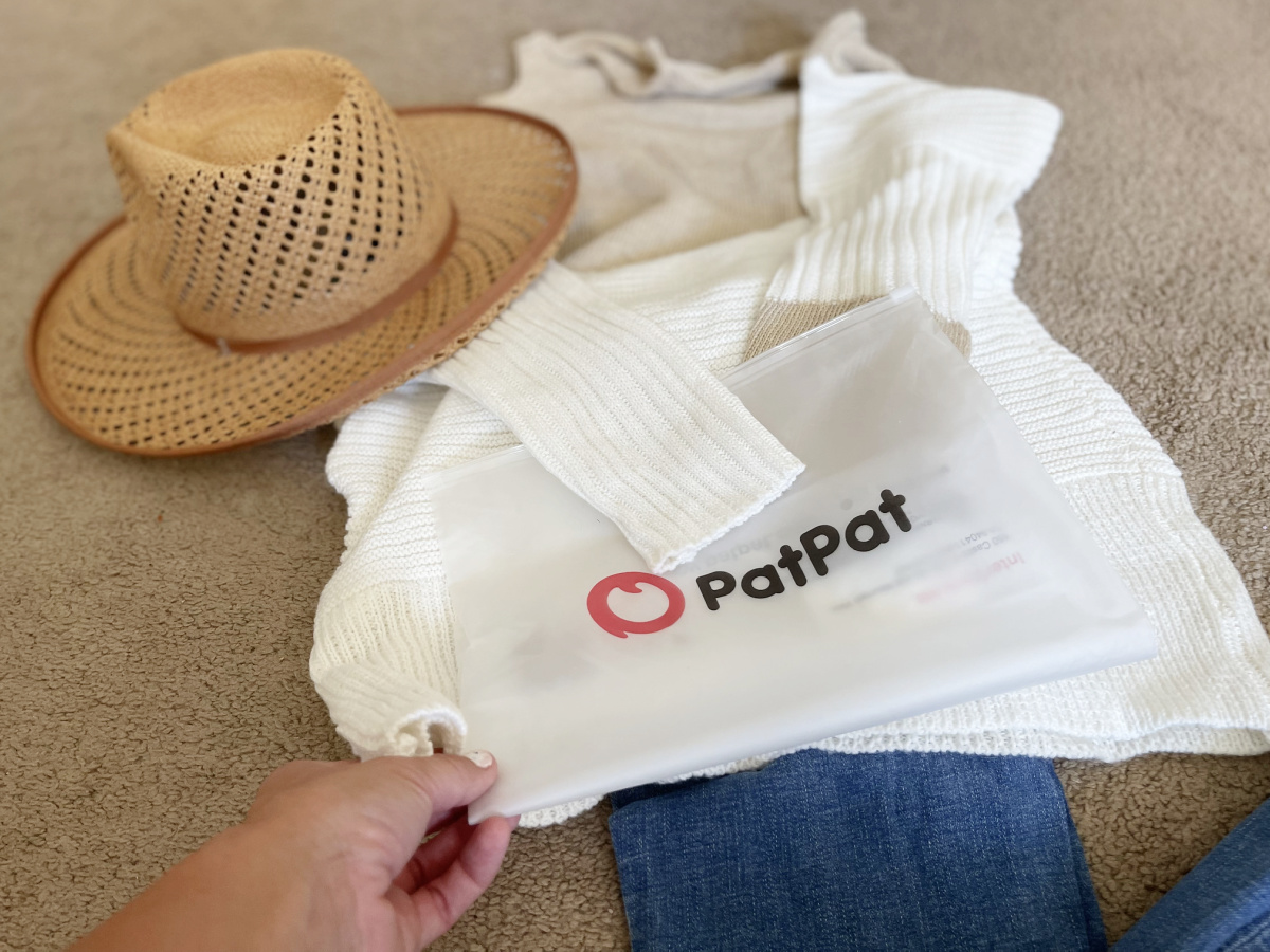patpat sweater with bag on floor