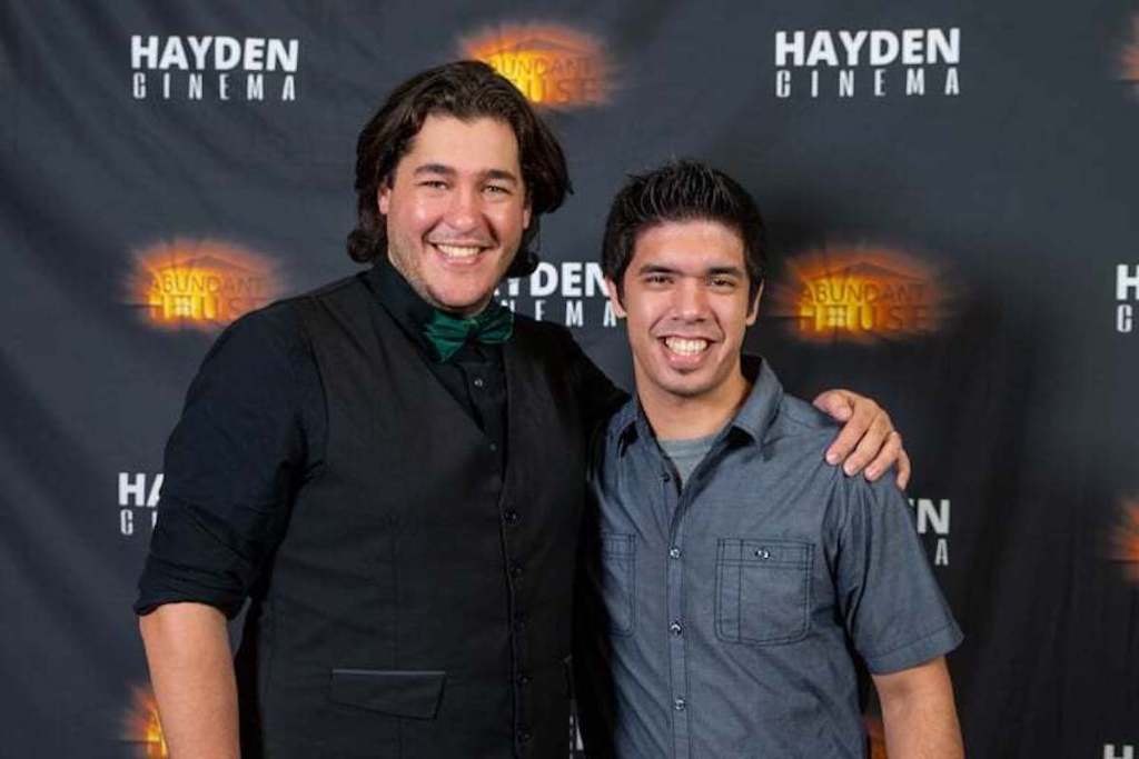 two men posing for picture on red carpet