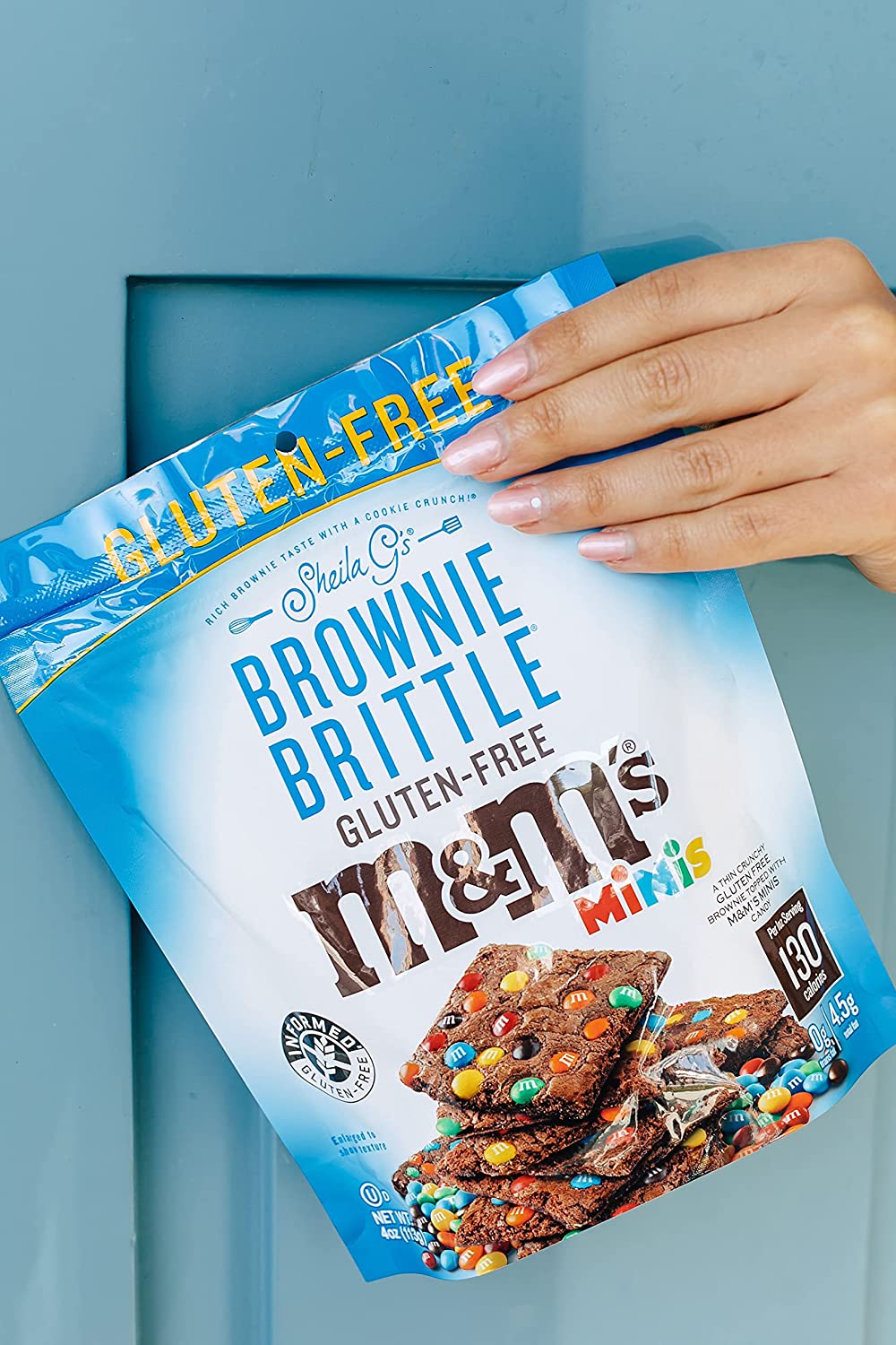 holding a bag of brownie brittle