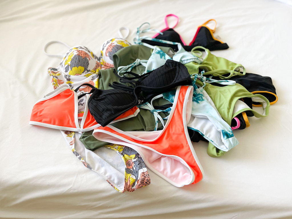pile of Shein bathing suits on counter 
