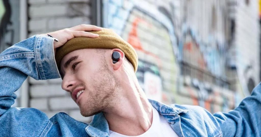 man with earbuds in his ear 