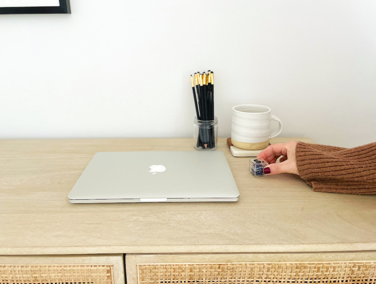 desk with laptop coffee mug and black pencils
