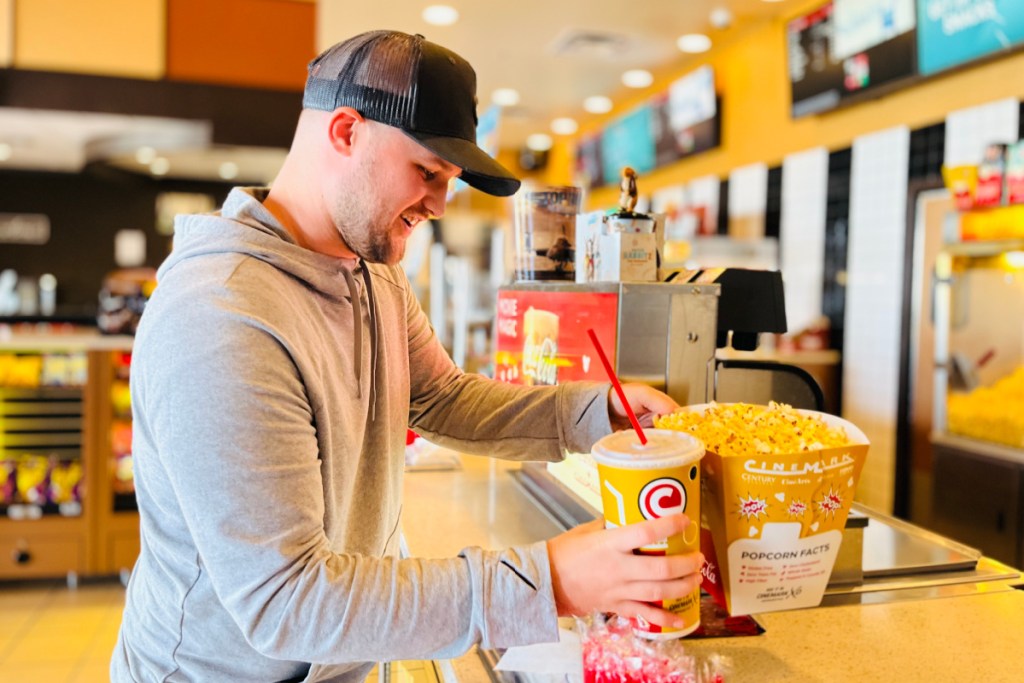 man standing at Cinemark concessions stand
