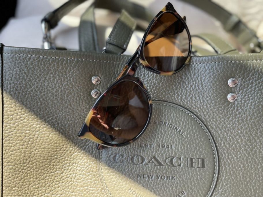 sunglasses on a coach bag