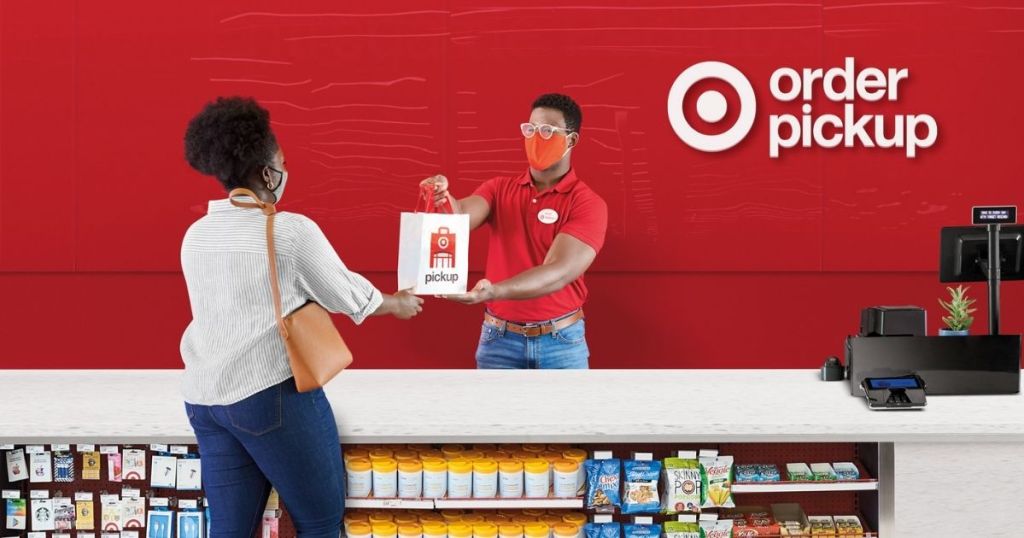 woman picking up items from Target kiosk