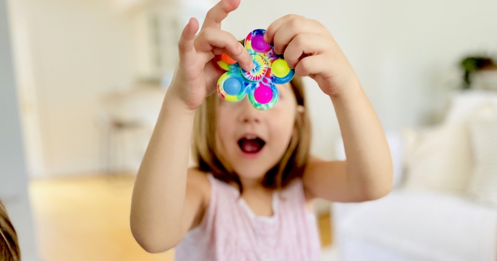 girl holding tie dye pop it fidget spinner