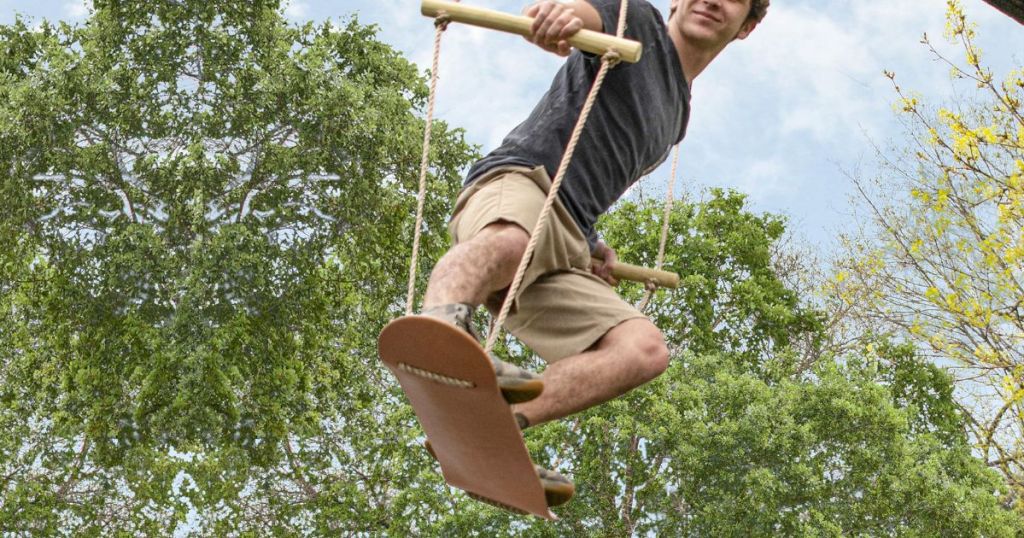 boy on a wooden skateboard swing