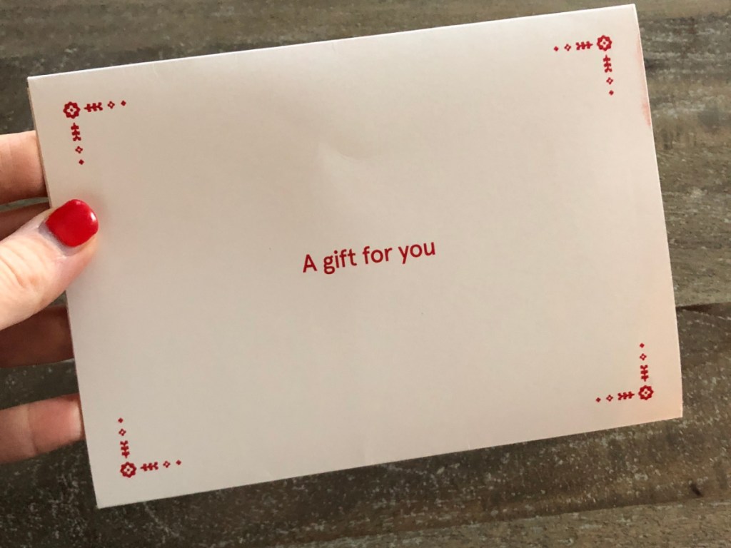 woman holding a gift for you envelope from chick-fil-a