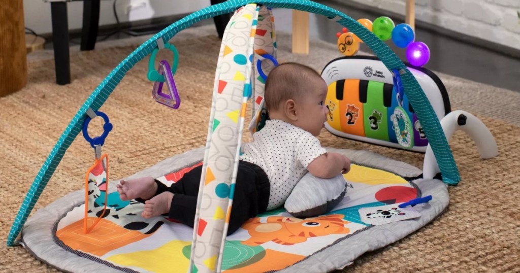Baby Einstein 4-in-1 Kickin' Tunes Music and Language Discovery Activity Gym baby on mat in living room