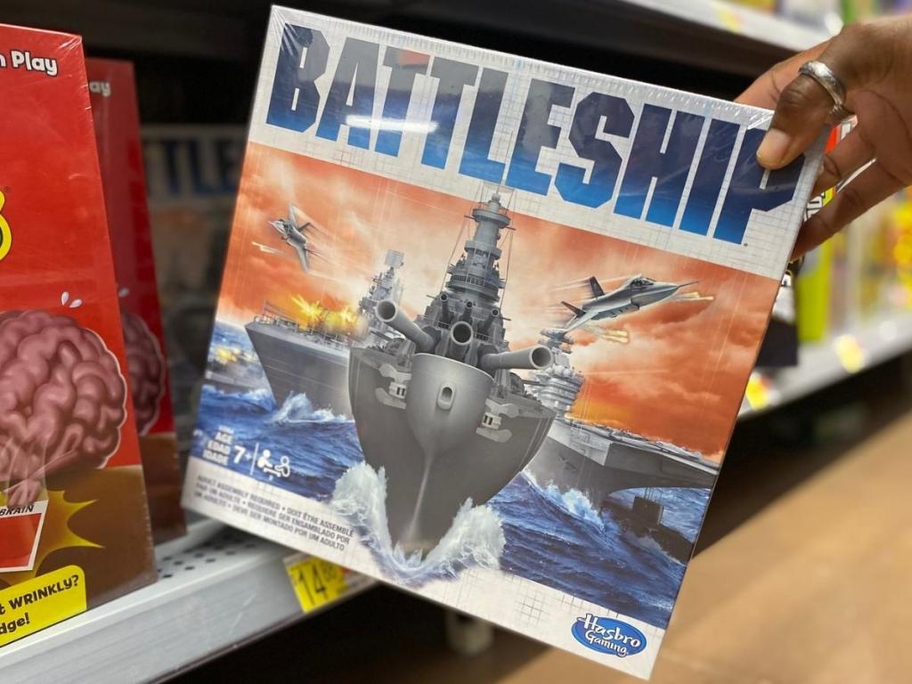 hand holding battleship game in store