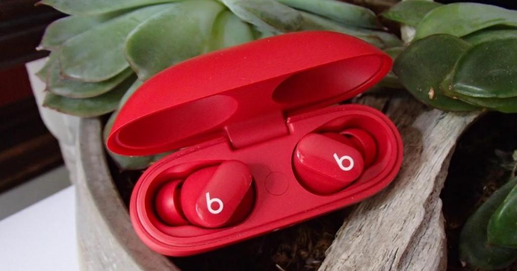beats studio buds in red with plant in background