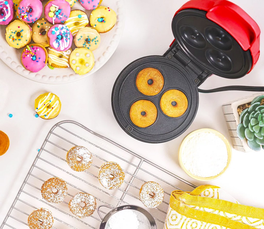 bella mini donut baker surrounded by mini donuts