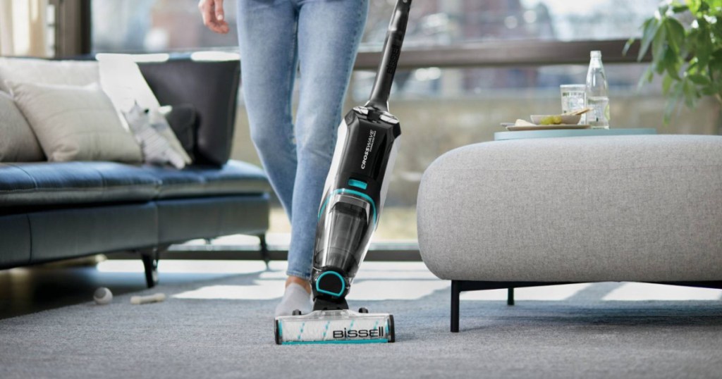 woman in living room with vacuum