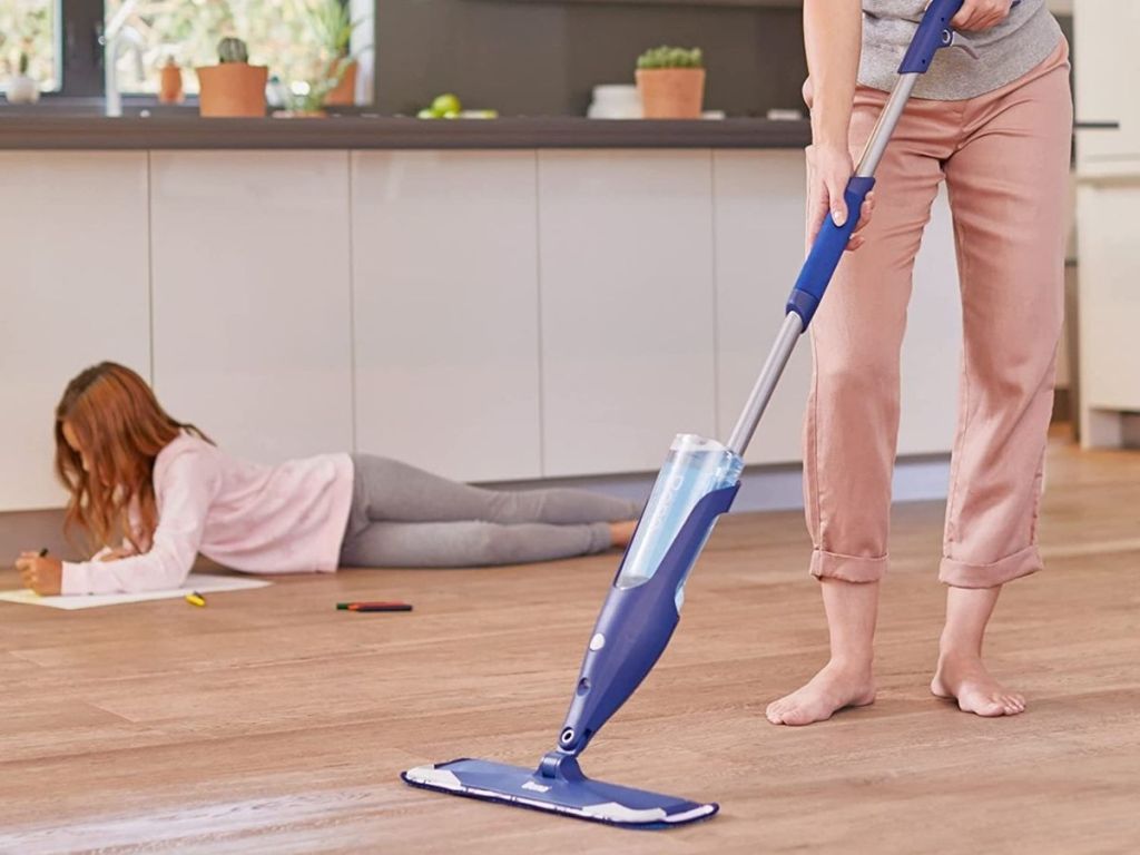 woman steam mopping floor