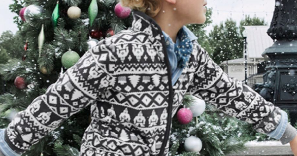 young child wearing a patterned fleece jacket