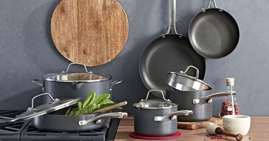grey pots and pans set on stove and kitchen counter