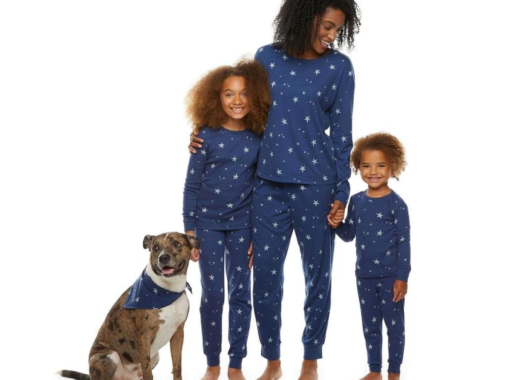 family and dog wearing matching celestial winter pajamas