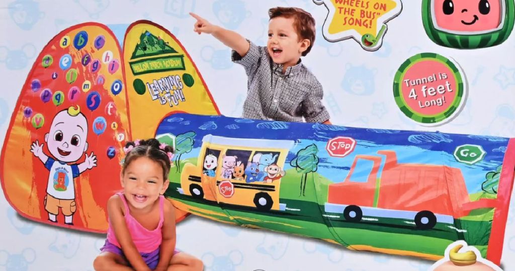 2 children in front of toy tent 