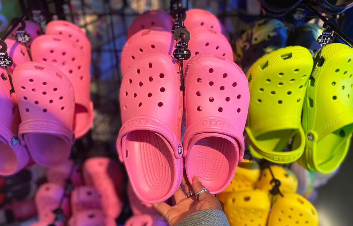 holding pink kids crocs