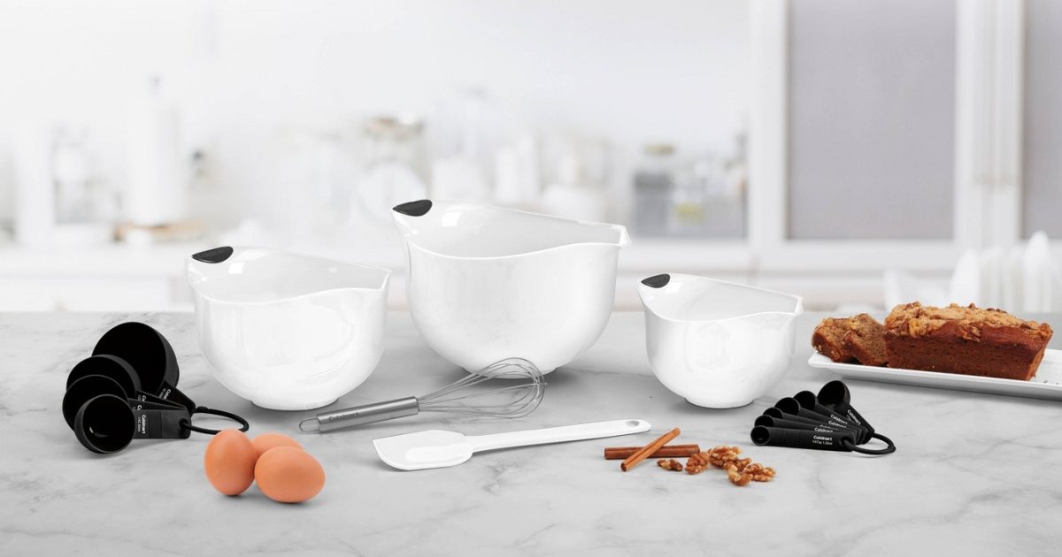 mixing bowls and measuring spoons and baking ingredients on kitchen island