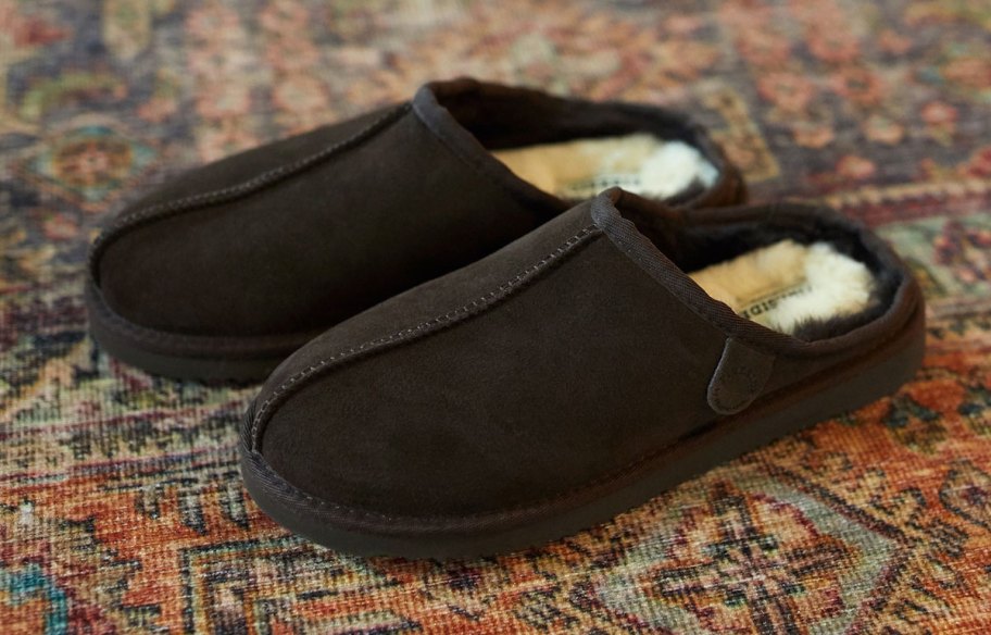 pair of black slippers on rug