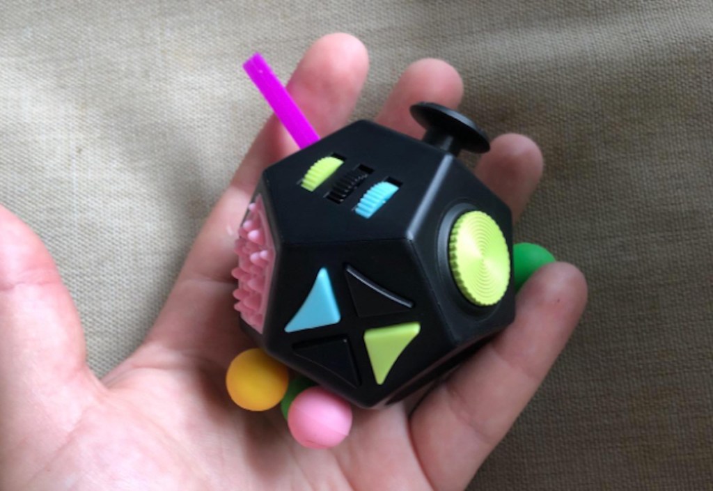 hand holding a Dodecagon Fidget Cube in palm