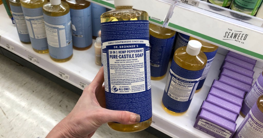woman holding bottle of Dr Bronners Peppermint Soap