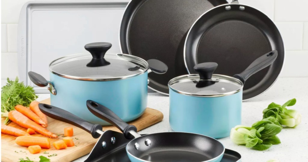 teal cookware set with vegetables on counter 
