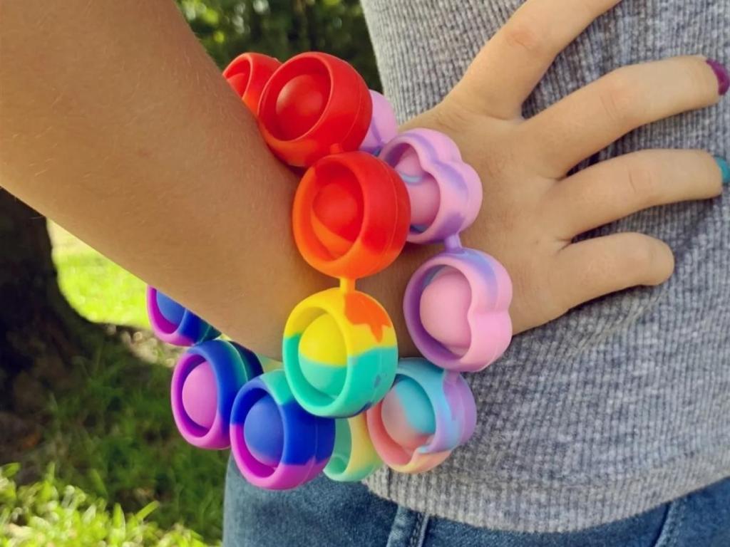 multi color fidget pop bracelet on girl's wrist