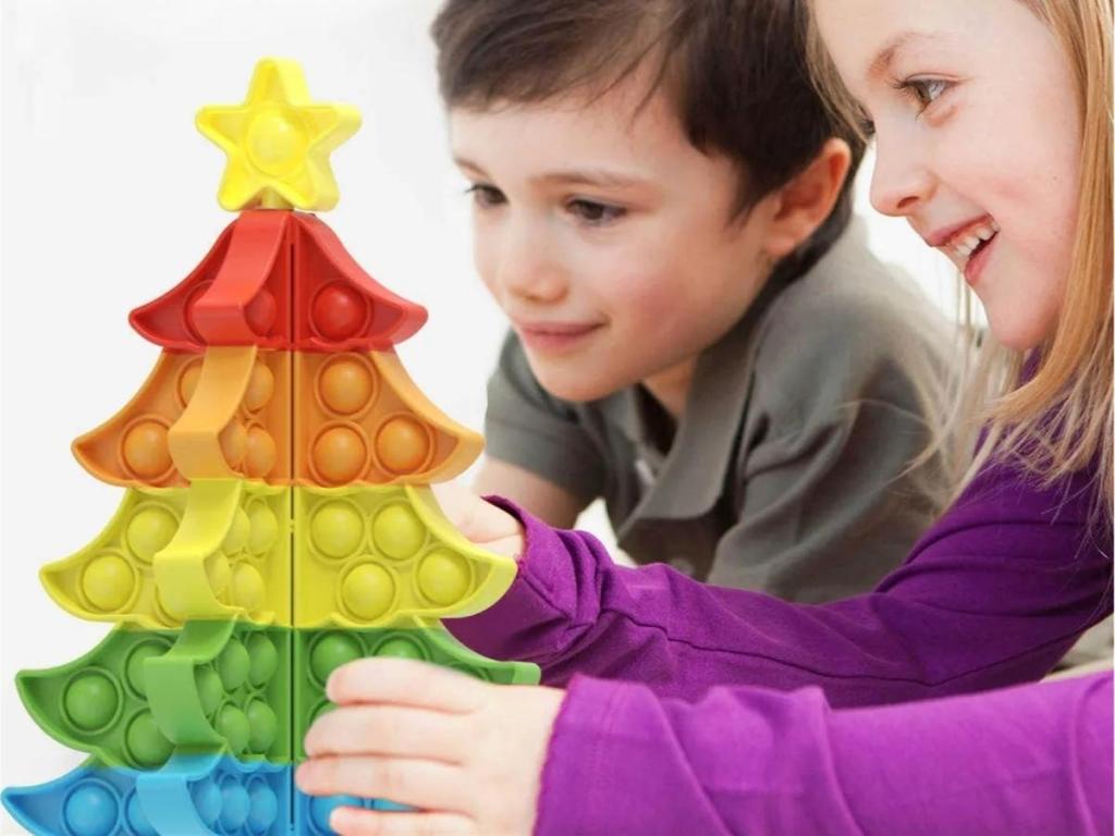 kids playing with pop it christmas tree set