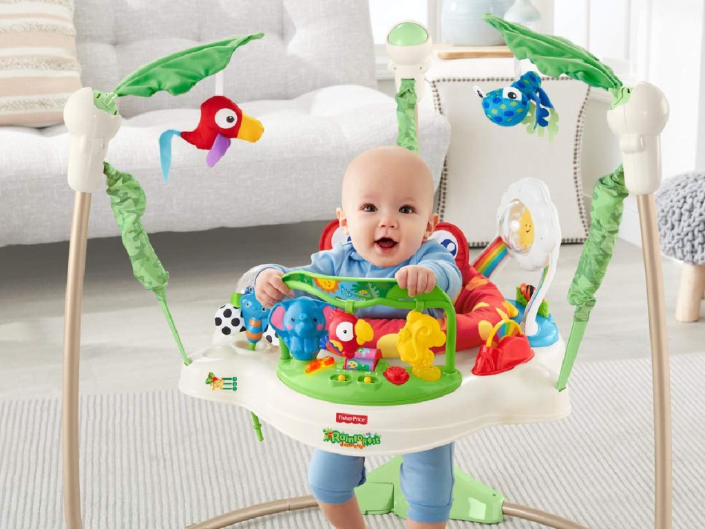 baby in a Fisher-Price Rainforest Jumperoo toy