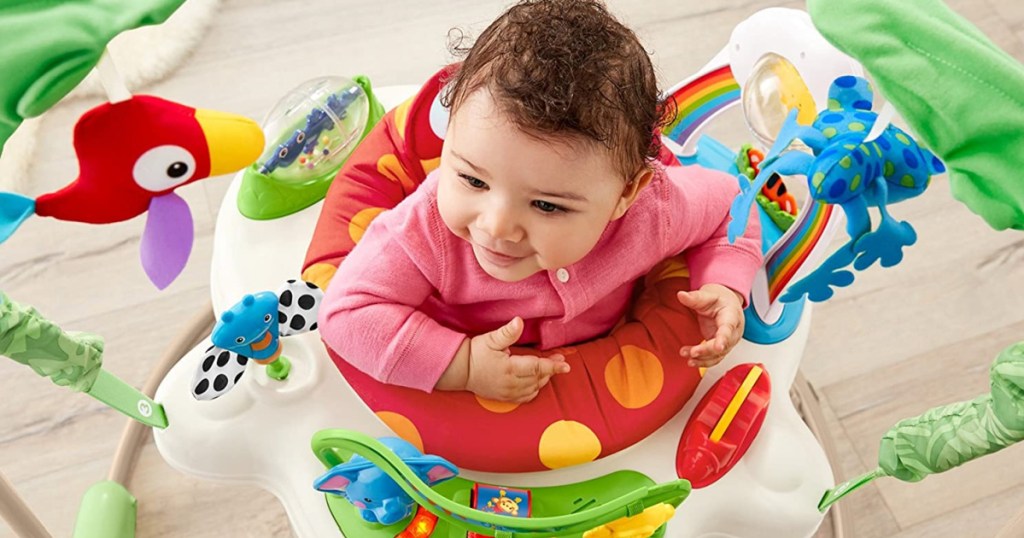 baby laying in a jumparoo toy