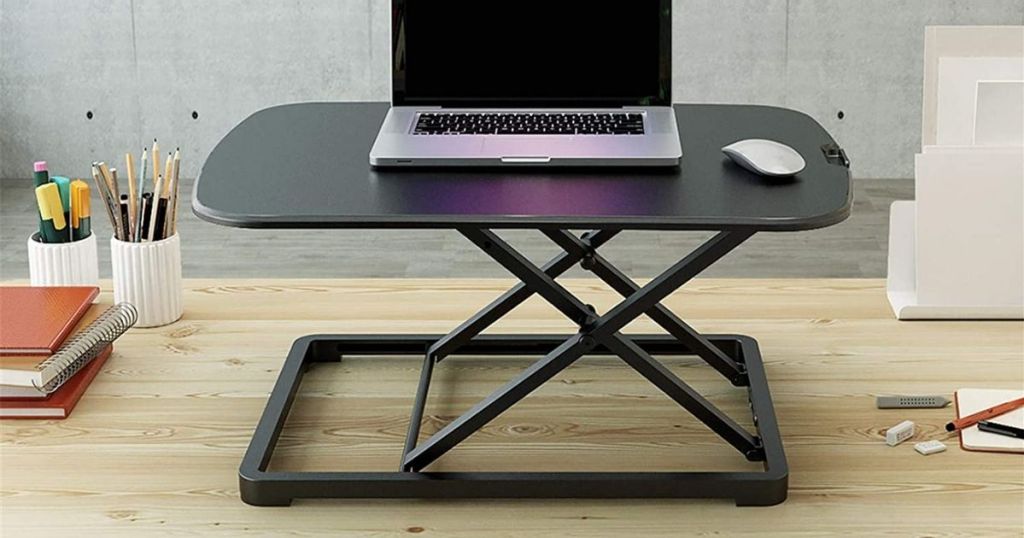 black desk riser with laptop and mouse