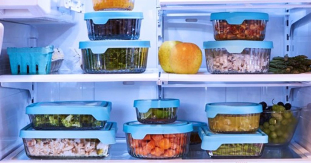 Food in glass storage containers on fridge shelves