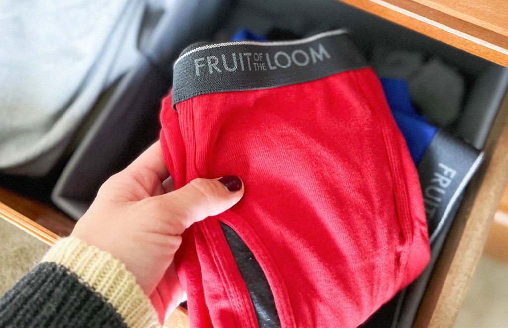 holding red pair of boxers